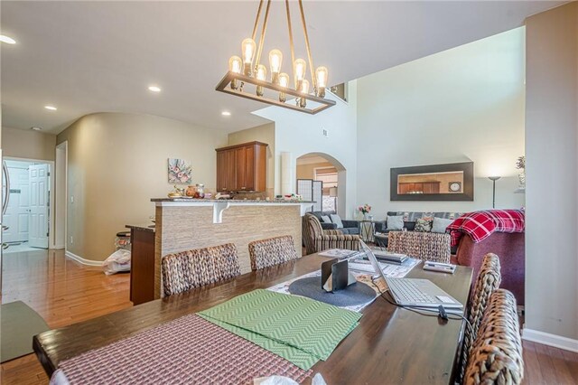 13943 Sunfish Bnd, Alpharetta, GA 30004 - dining space with baseboards, arched walkways, wood finished floors, and recessed lighting
