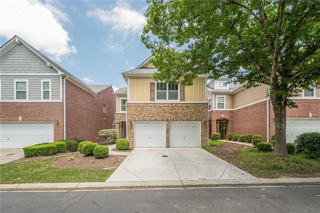 13943 Sunfish Bnd, Alpharetta, GA 30004 - view of front facade with board and batten siding, brick siding, an attached garage, and driveway