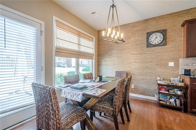 13943 Sunfish Bnd, Alpharetta, GA 30004 - dining room with an inviting chandelier, baseboards, light wood finished floors, and wallpapered walls