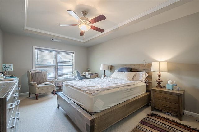 13943 Sunfish Bnd, Alpharetta, GA 30004 - bedroom with ornamental molding, a tray ceiling, light colored carpet, and visible vents