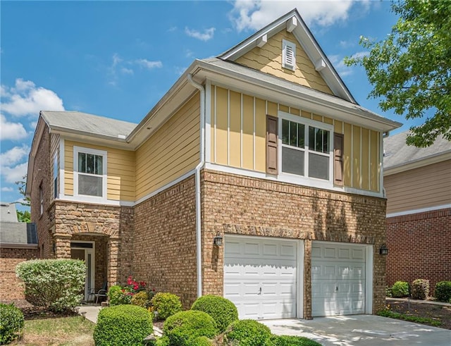 13943 Sunfish Bnd, Alpharetta, GA 30004 - view of front facade with a garage, board and batten siding, concrete driveway, and brick siding