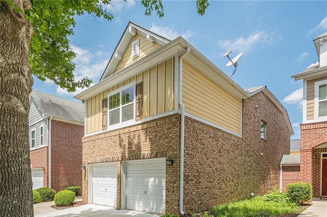 13943 Sunfish Bnd, Alpharetta, GA 30004 - view of property exterior with an attached garage, board and batten siding, brick siding, and concrete driveway