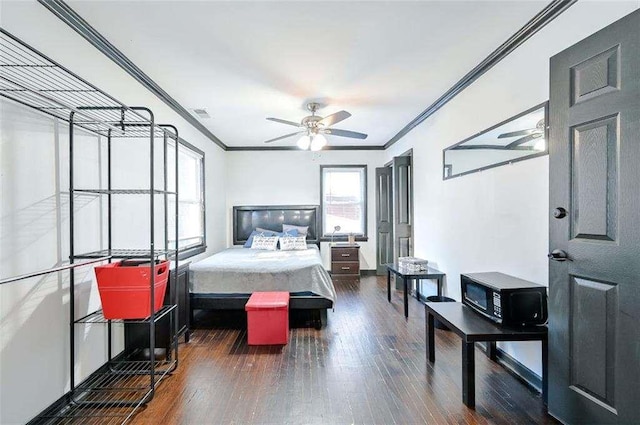 bedroom featuring crown molding, ceiling fan, and dark hardwood / wood-style flooring