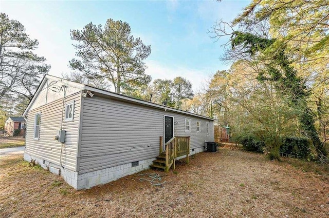 view of side of property with central AC unit