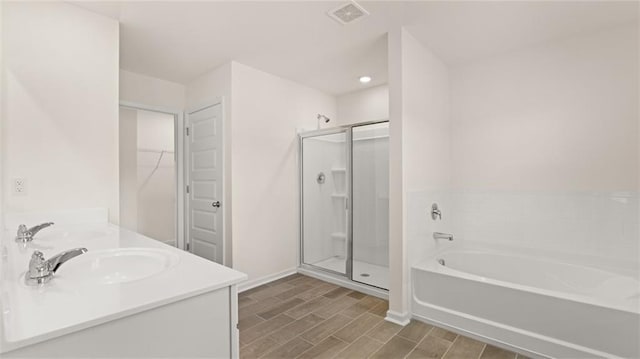 bathroom featuring a garden tub, a shower stall, visible vents, and wood finish floors