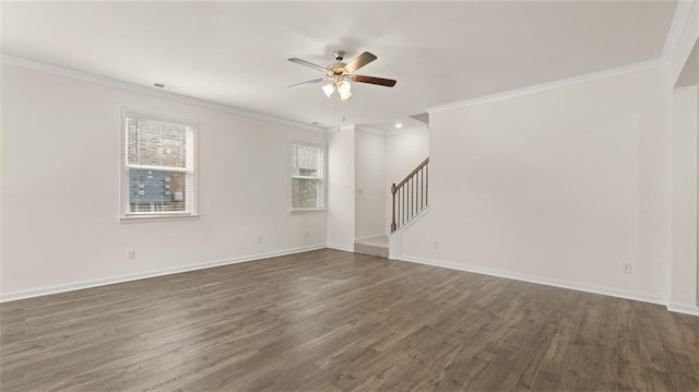 empty room featuring baseboards, crown molding, stairway, and dark wood-type flooring