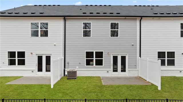 rear view of house featuring a yard, french doors, a patio area, and central air condition unit