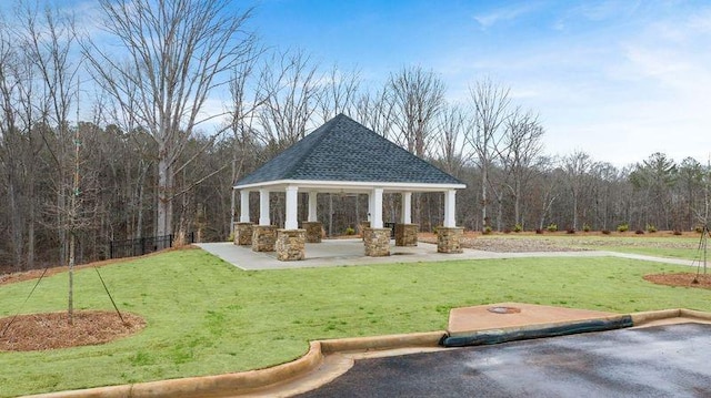 surrounding community with a lawn and a gazebo