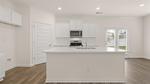 kitchen featuring visible vents, white cabinets, appliances with stainless steel finishes, a kitchen island with sink, and a sink