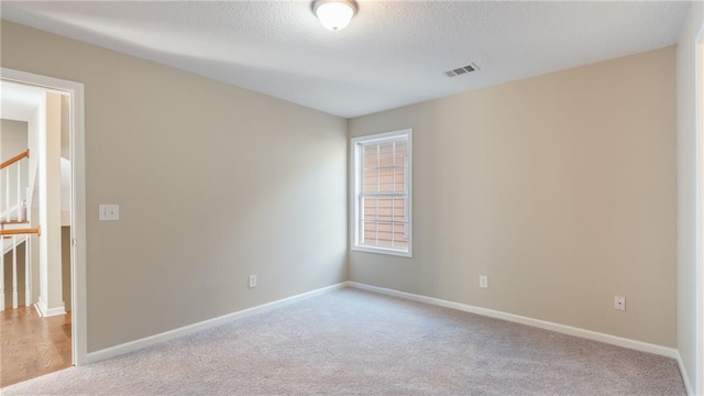 empty room featuring light colored carpet