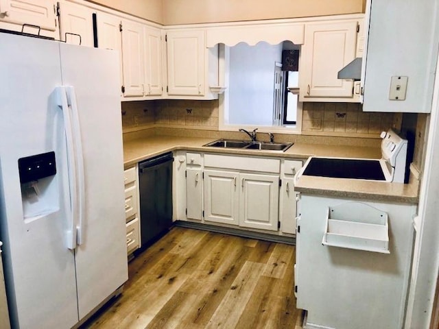 kitchen featuring sink, white cabinetry, white appliances, light hardwood / wood-style floors, and decorative backsplash