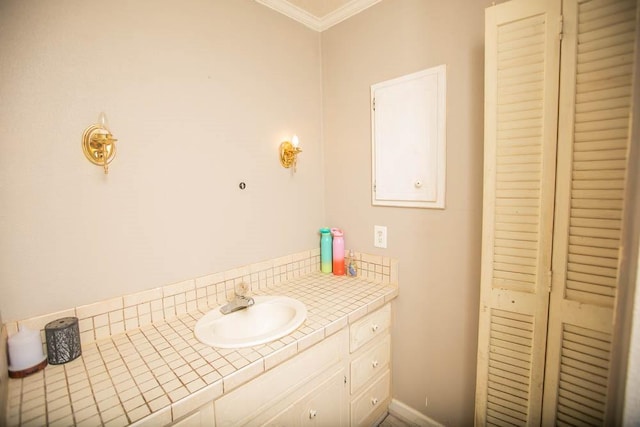 bathroom with vanity and ornamental molding