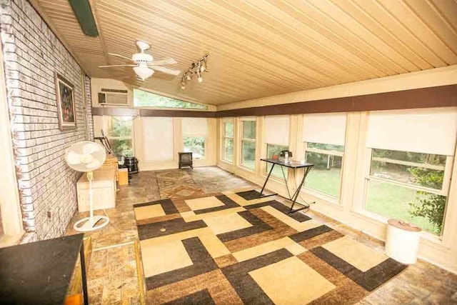 unfurnished sunroom with vaulted ceiling, wooden ceiling, and a healthy amount of sunlight