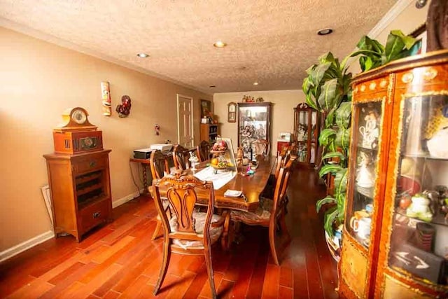 dining area with a textured ceiling and hardwood / wood-style floors