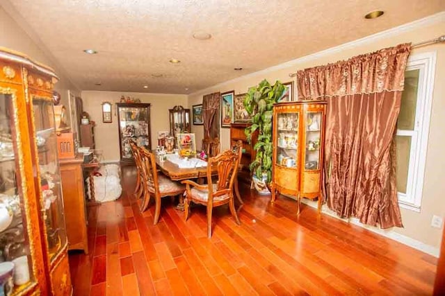 dining area with hardwood / wood-style flooring and a textured ceiling