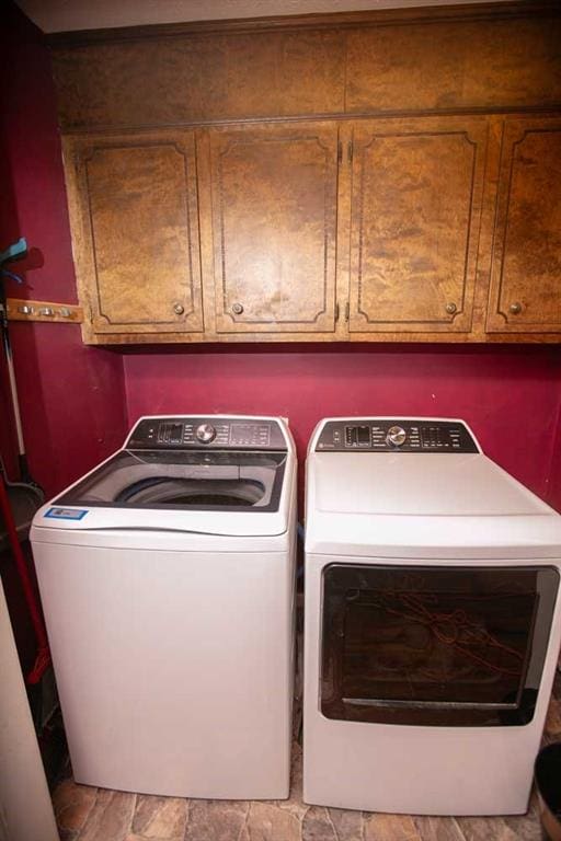 laundry room featuring cabinets and separate washer and dryer