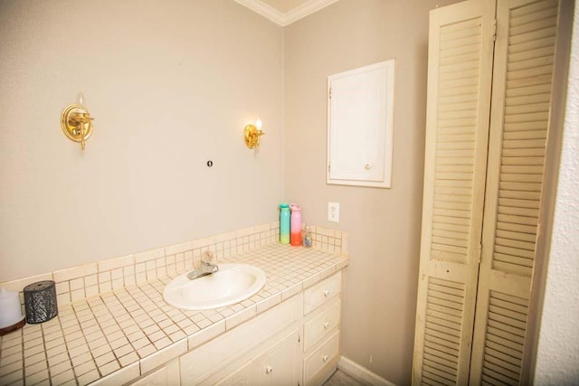 bathroom with vanity and crown molding