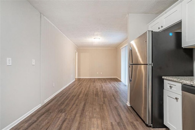 4442 Cedar Ridge Trl, Stone Mountain, GA 30083 - kitchen with stainless steel appliances, dark wood-type flooring, white cabinetry, a textured ceiling, and light stone counters