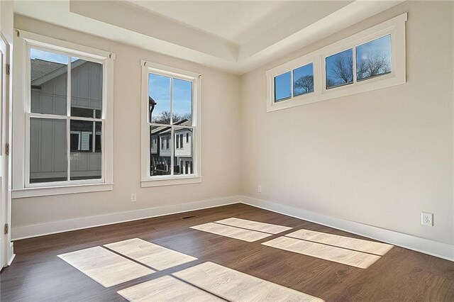 full bathroom with hardwood / wood-style flooring, vanity, tiled shower / bath, and toilet