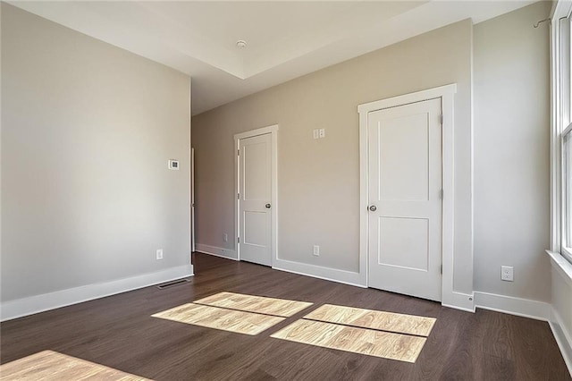 unfurnished bedroom featuring dark hardwood / wood-style floors