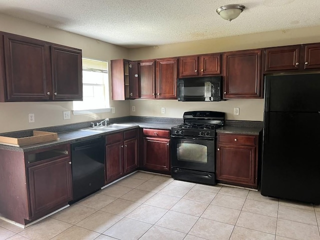 6157 Redtop Loop, Fairburn, GA 30213 - kitchen with black appliances, dark countertops, light tile patterned floors, a textured ceiling, and reddish brown cabinets
