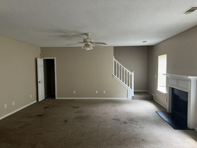 6157 Redtop Loop, Fairburn, GA 30213 - unfurnished living room featuring stairway, a ceiling fan, carpet flooring, a textured ceiling, and a fireplace with raised hearth
