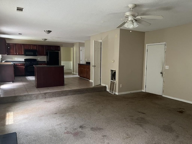 6157 Redtop Loop, Fairburn, GA 30213 - kitchen with black appliances, light colored carpet, a center island, ceiling fan, and open floor plan
