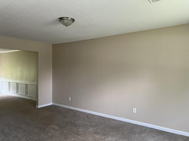 6157 Redtop Loop, Fairburn, GA 30213 - spare room with dark colored carpet and a textured ceiling