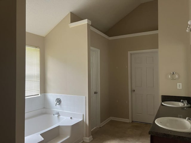 6157 Redtop Loop, Fairburn, GA 30213 - bathroom with vaulted ceiling, a bath, and double vanity