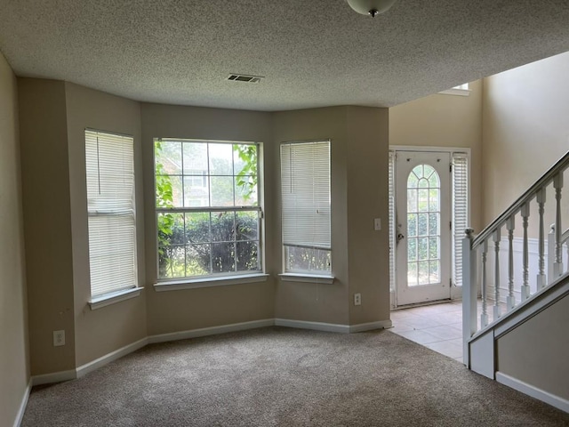 6157 Redtop Loop, Fairburn, GA 30213 - carpeted foyer entrance featuring healthy amount of natural light, stairway, and a textured ceiling
