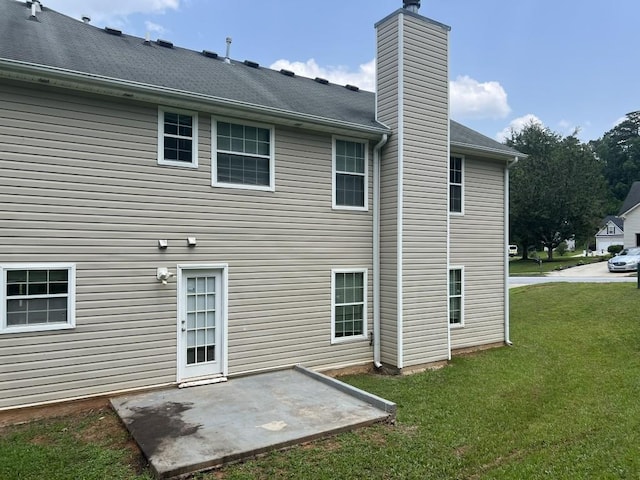 6157 Redtop Loop, Fairburn, GA 30213 - rear view of house featuring a patio area, a lawn, and a chimney