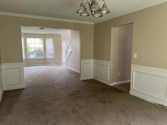 6157 Redtop Loop, Fairburn, GA 30213 - spare room featuring dark colored carpet, a chandelier, wainscoting, crown molding, and a textured ceiling