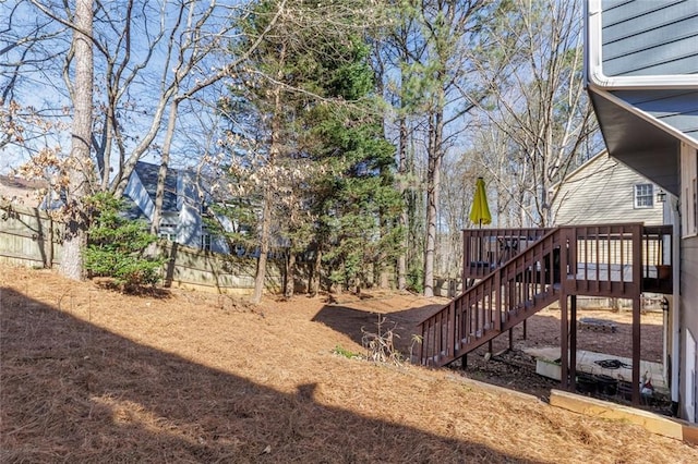 view of yard with stairway, fence, and a deck