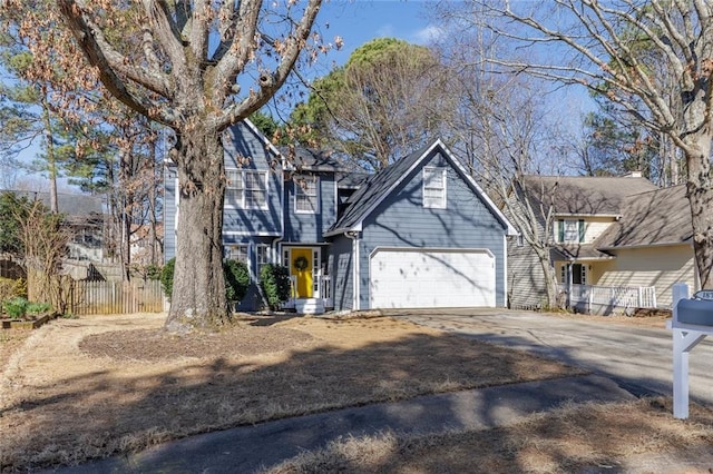 view of front of house featuring a garage, fence, and concrete driveway