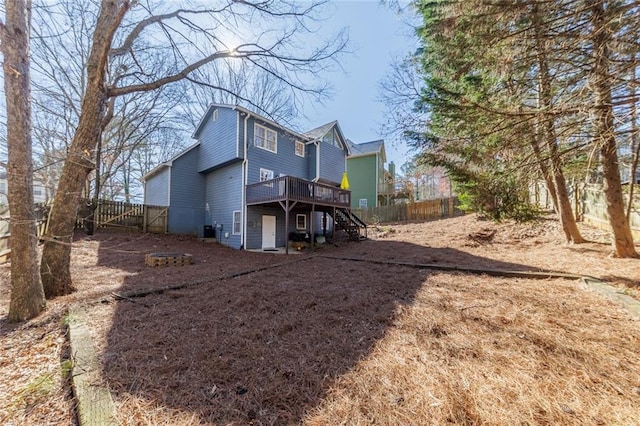 back of property featuring stairs, central AC unit, a fenced backyard, and a wooden deck