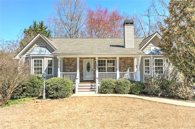 189 Meadow Spring Dr, Temple, GA 30179 - view of front facade with stone siding, a chimney, covered porch, and roof with shingles