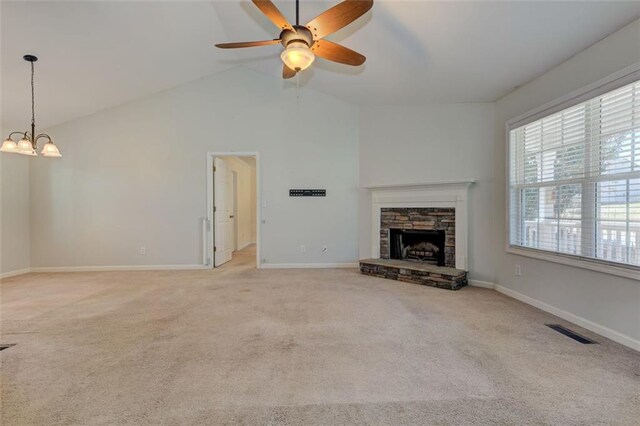189 Meadow Spring Dr, Temple, GA 30179 - unfurnished living room featuring a chandelier, light colored carpet, ceiling fan, a stone fireplace, and vaulted ceiling
