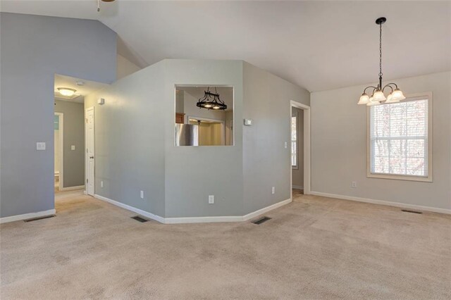 189 Meadow Spring Dr, Temple, GA 30179 - empty room with a chandelier, carpet flooring, vaulted ceiling, baseboards, and a ceiling fan