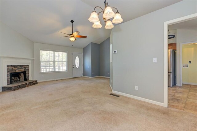 189 Meadow Spring Dr, Temple, GA 30179 - unfurnished living room with light carpet, a ceiling fan, lofted ceiling, baseboards, and a chandelier