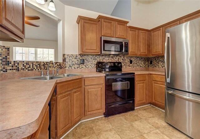 189 Meadow Spring Dr, Temple, GA 30179 - kitchen with stainless steel appliances, a sink, light countertops, backsplash, and vaulted ceiling