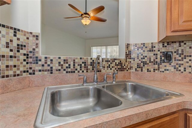 189 Meadow Spring Dr, Temple, GA 30179 - kitchen view of a sink, light countertops, ceiling fan, light brown cabinetry, and backsplash