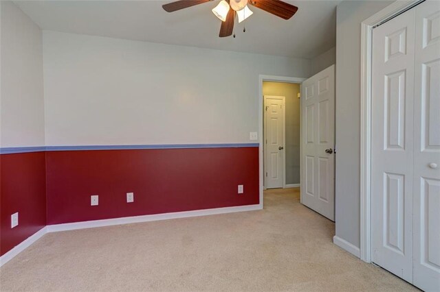 189 Meadow Spring Dr, Temple, GA 30179 - unfurnished bedroom featuring light carpet, baseboards, a ceiling fan, and a closet