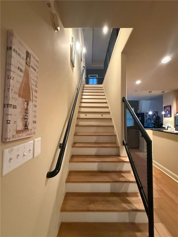 staircase featuring wood-type flooring