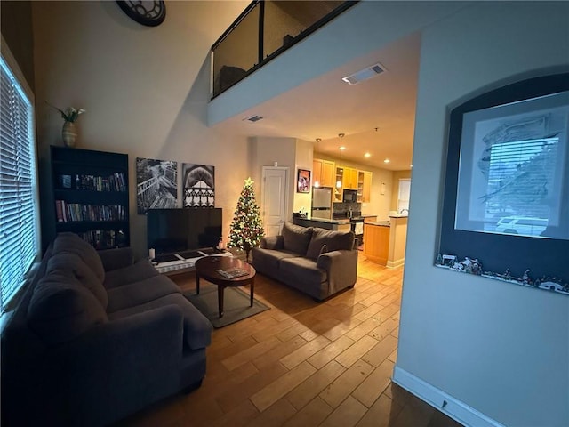 living room with plenty of natural light and light hardwood / wood-style floors