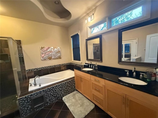 bathroom featuring vanity, plus walk in shower, and tile patterned flooring