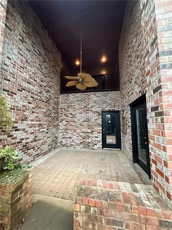 doorway to property with ceiling fan and a patio area