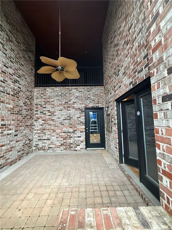 doorway to property featuring a patio and ceiling fan