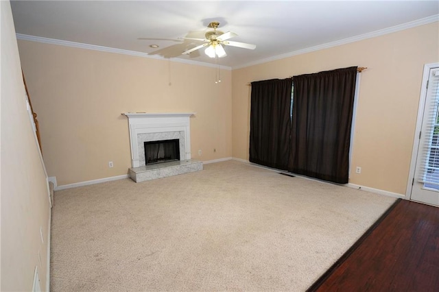 unfurnished living room featuring a fireplace, ornamental molding, light wood-type flooring, and ceiling fan