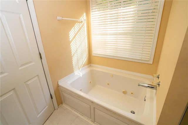 bathroom featuring a bath and a healthy amount of sunlight