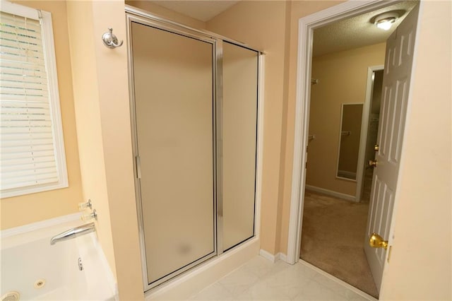 bathroom with independent shower and bath and a textured ceiling